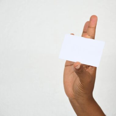 A close-up of a hand holding a blank card, ideal for copy space.