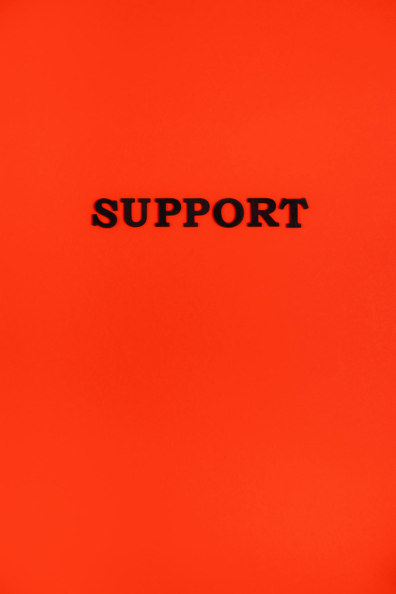 Vibrant red background with the word 'Support' centered in black text.
